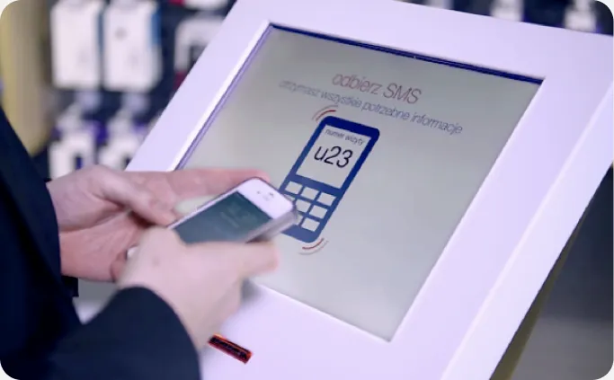 A customer scanning an SMS ticket at the kiosk